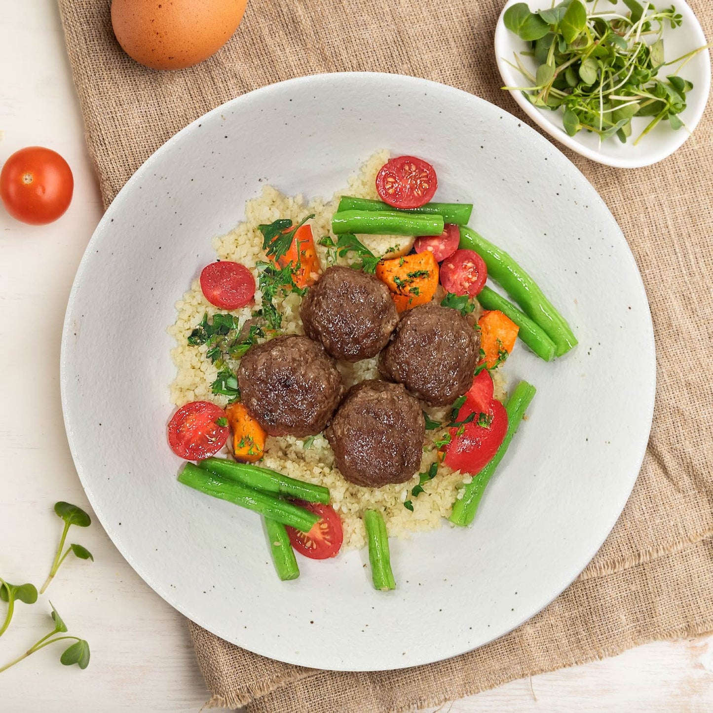 B. Braised Beef Meatball In Italian Tomato Sauce W/ Seasonal Vegetables And Pumpkin Couscous Mix Rice