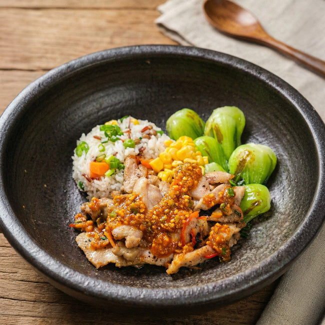 Fittery Indonesian Nasi Goreng Chicken signature meal with sautéed vegetables and healthy fried rice in a bowl.