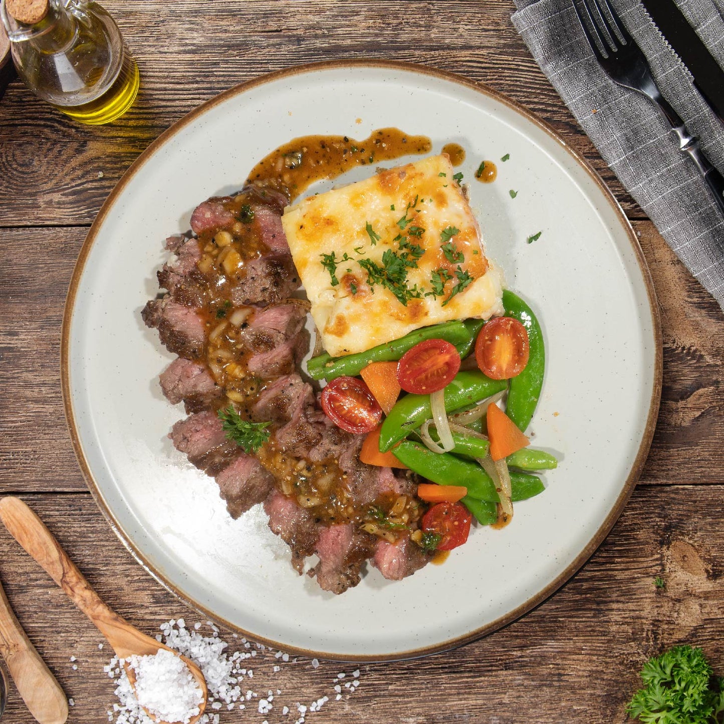 Grass Fed Ribeye Steak W/ Potato Scallopine, Sauteed Vegetables And Peppercorn Sauce