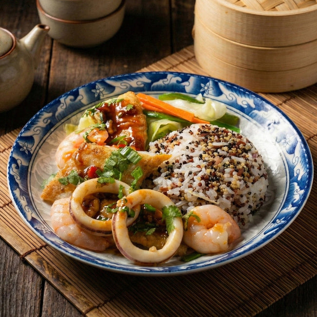 Fittery Tao O Seafood Casserole with seasonal greens and quinoa mix grains, served in a stylish dish.