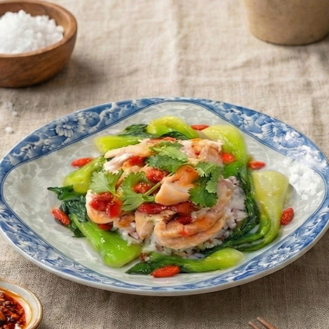 Fittery Chong Qing Chicken claypot with seasonal vegetables, taro, and mixed grains served in a signature meal presentation.