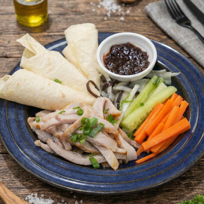 Fittery signature shredded pork loin with side salad and tortilla wrap on a plate, ready to serve.