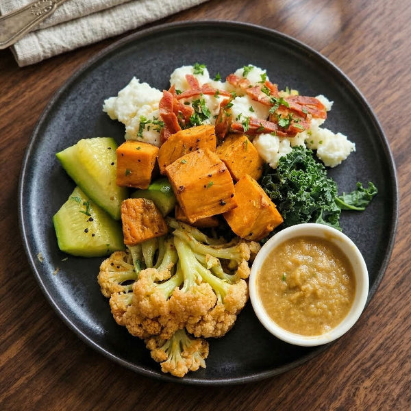 Spanish chorizo egg scramble with sweet potato and cumin hummus on a plate, served as a signature meal by Fittery.
